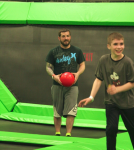 Man and Boy Playing Trampoline Dodgeball